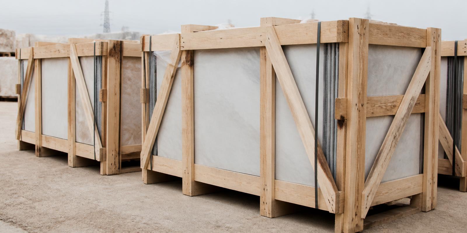 Timber export crates of edge-protected Shahabad limestone banded and staged for loading