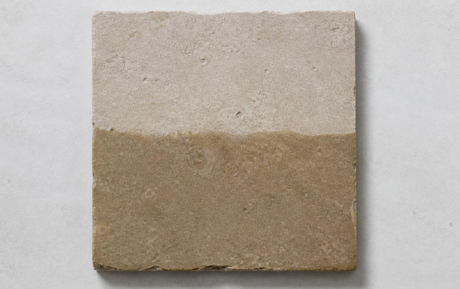 Shahabad limestone sample tile half wetted, showing the tonal shift between dry and wet stone